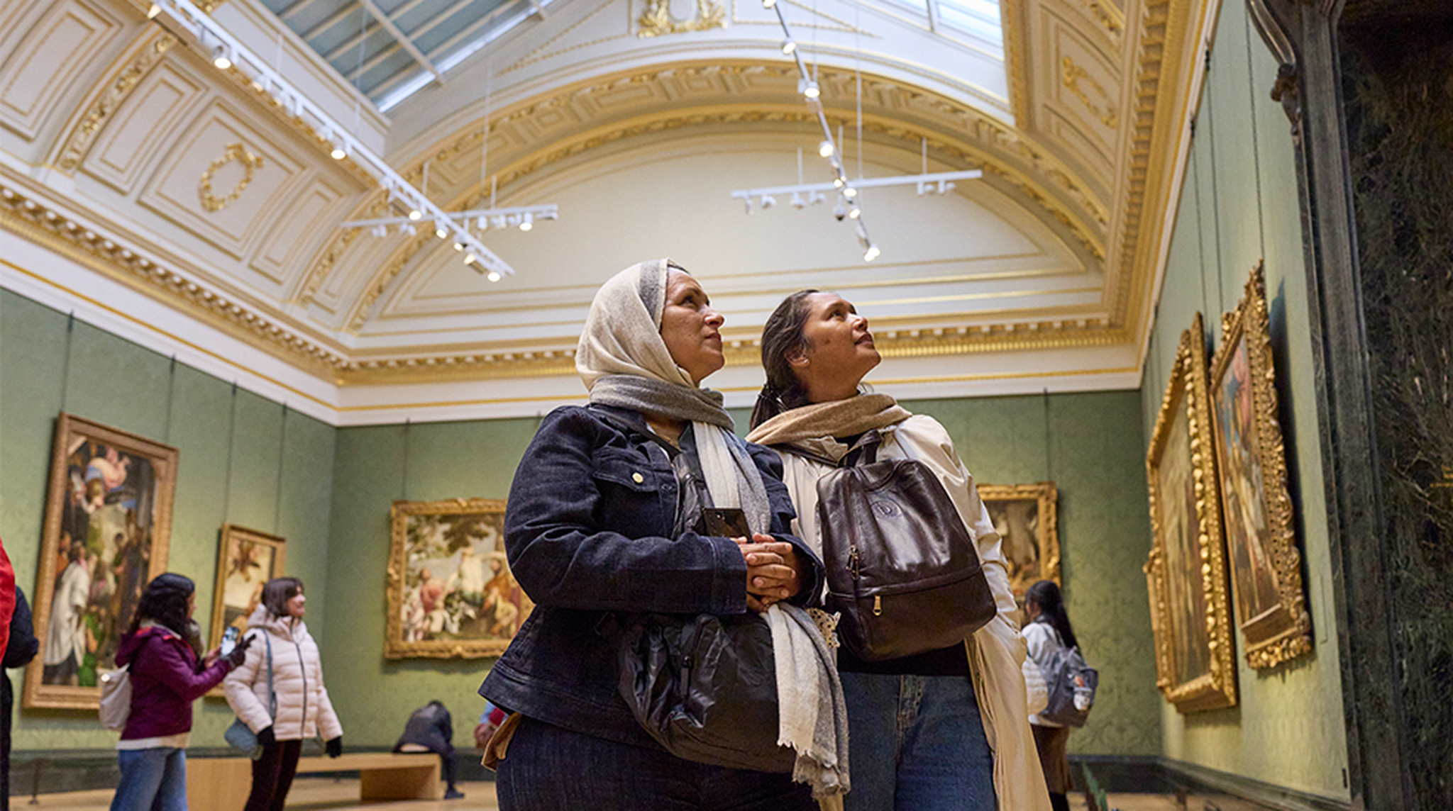 Two women admire art in The National Gallery