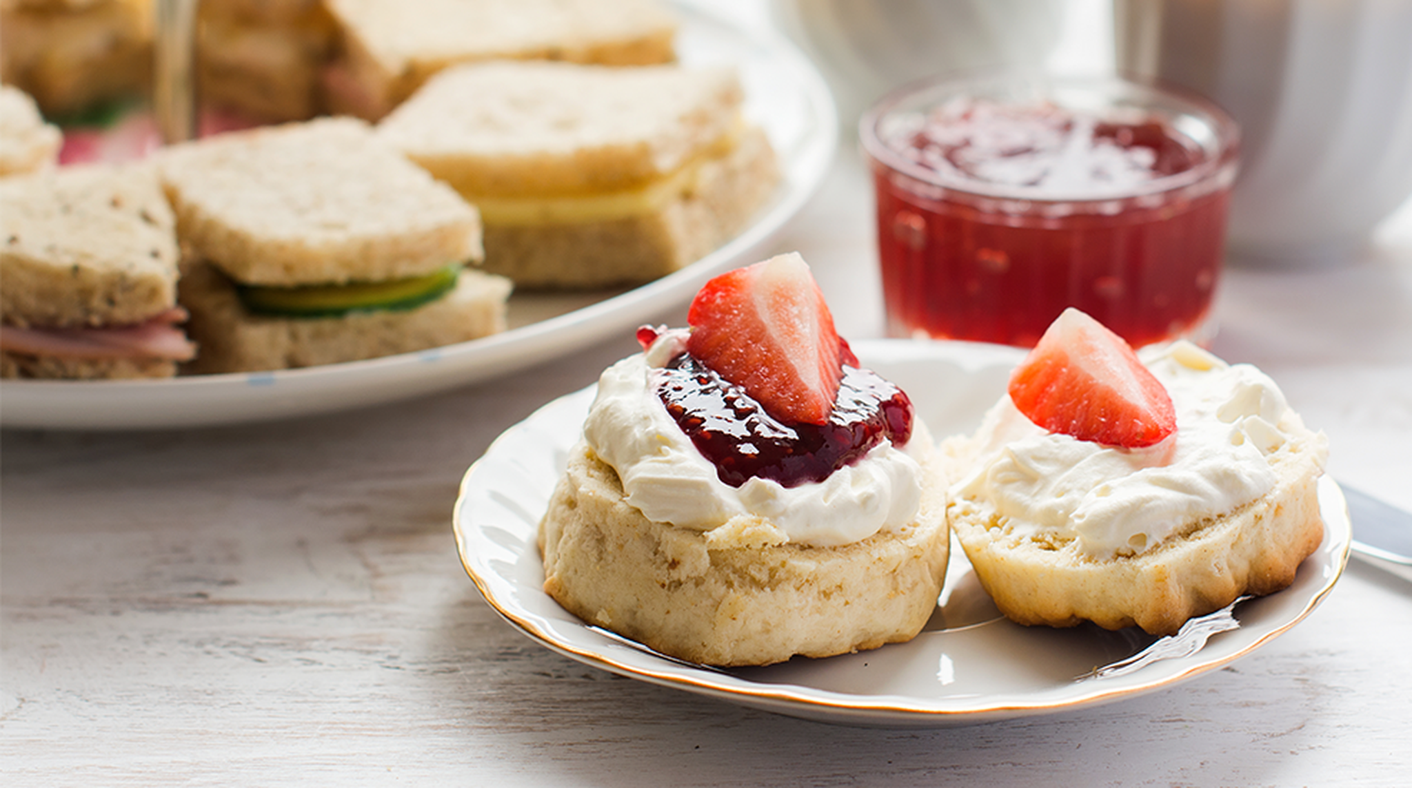 Close up of scones, jam, and strawberries