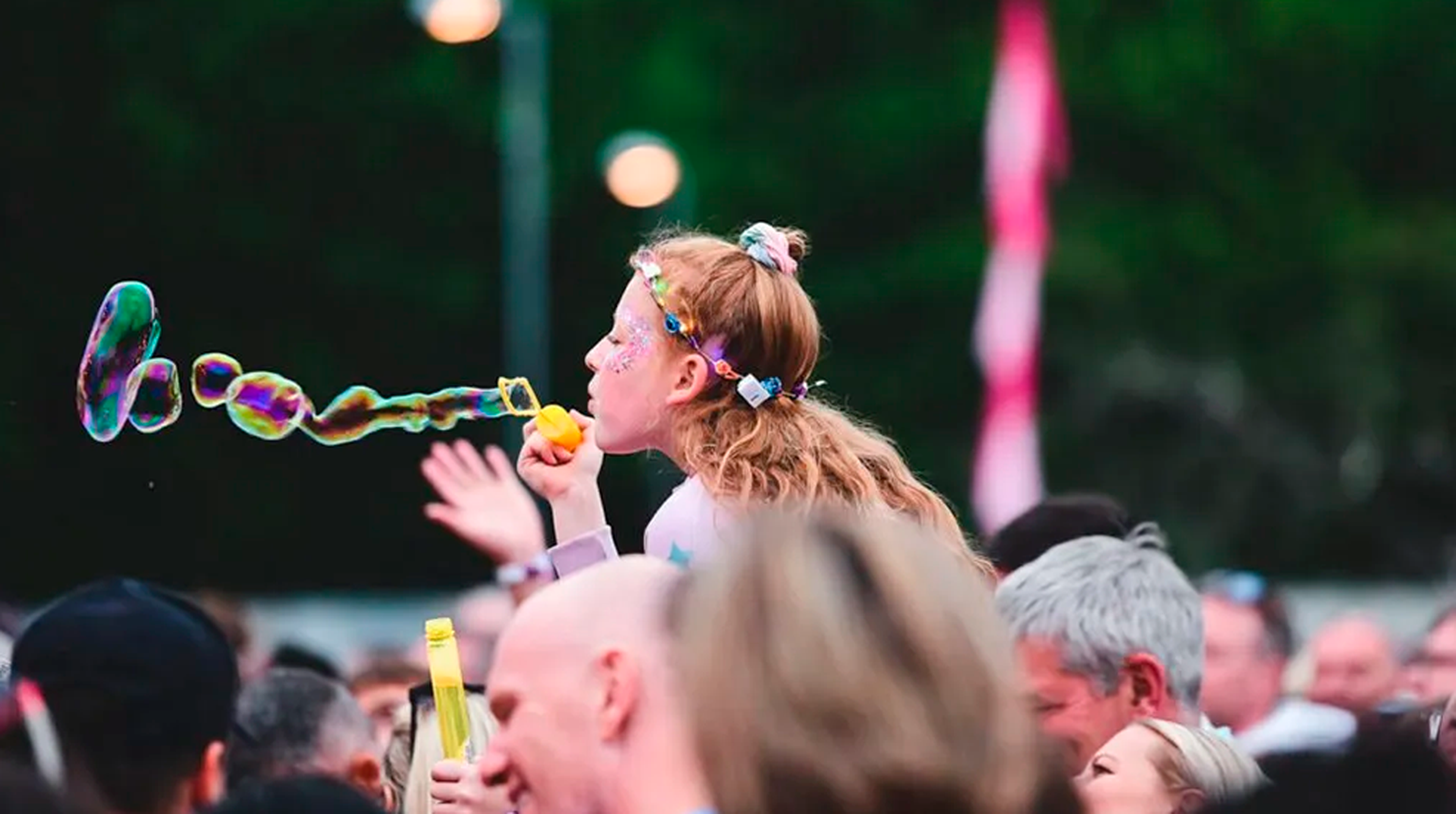 Girl blowing bubbles in crowd at Solihull Music Festival