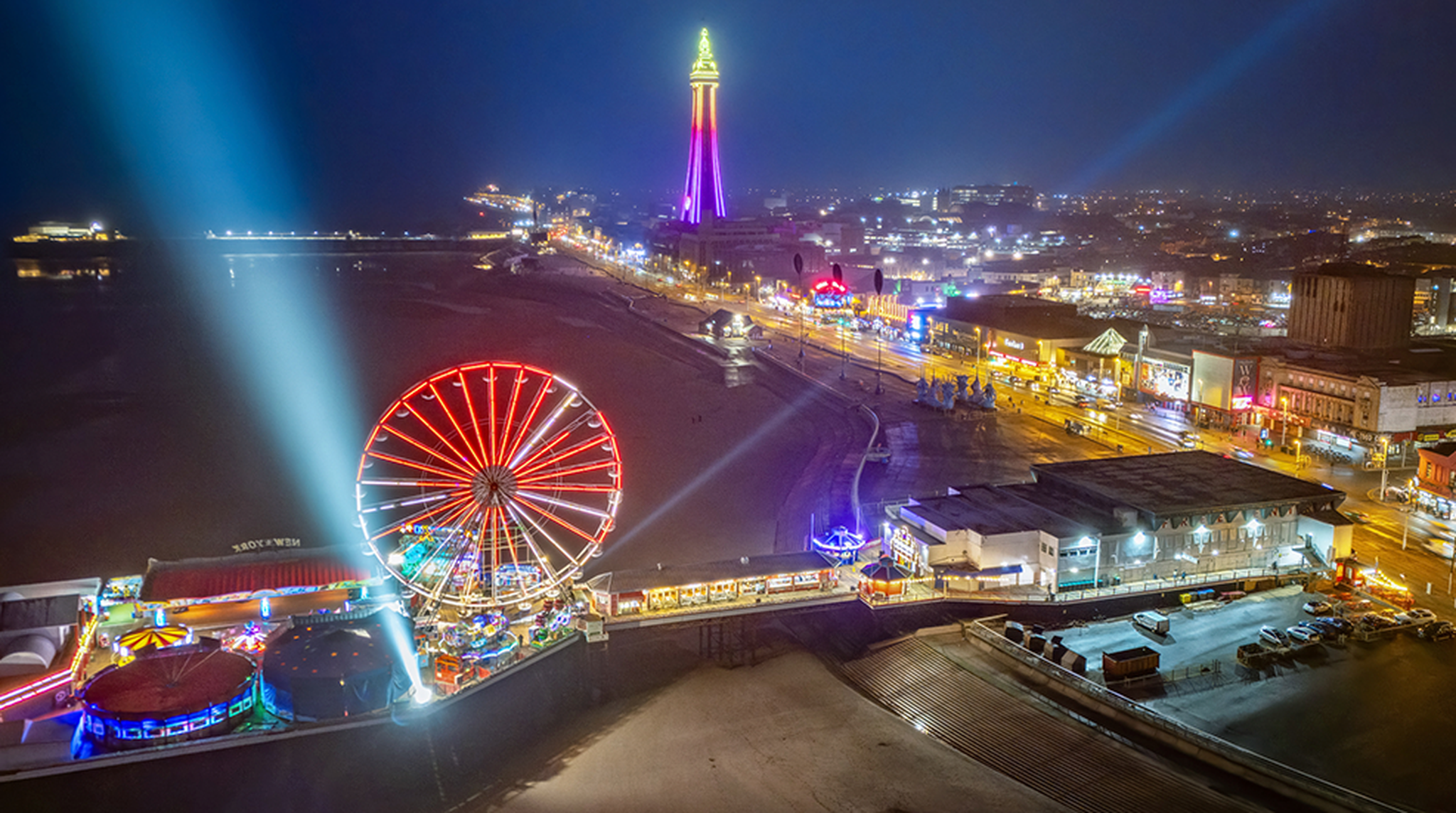 Aerial Image of Blackpool Central Pier and Blackpool Tower along the Fylde Coast, Lancashire during a lovely calm night on the Sea front.