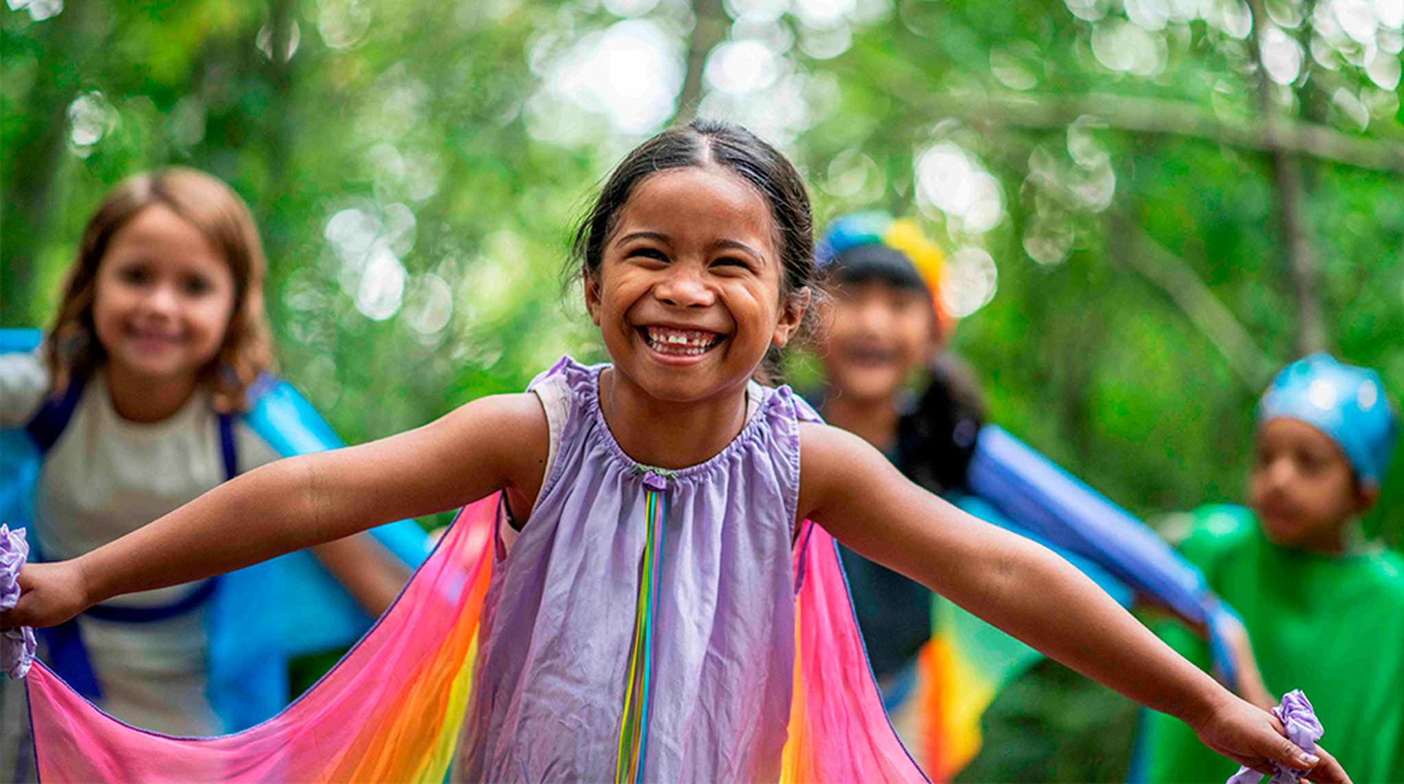 Children smiling at WWT Dragonfly festival