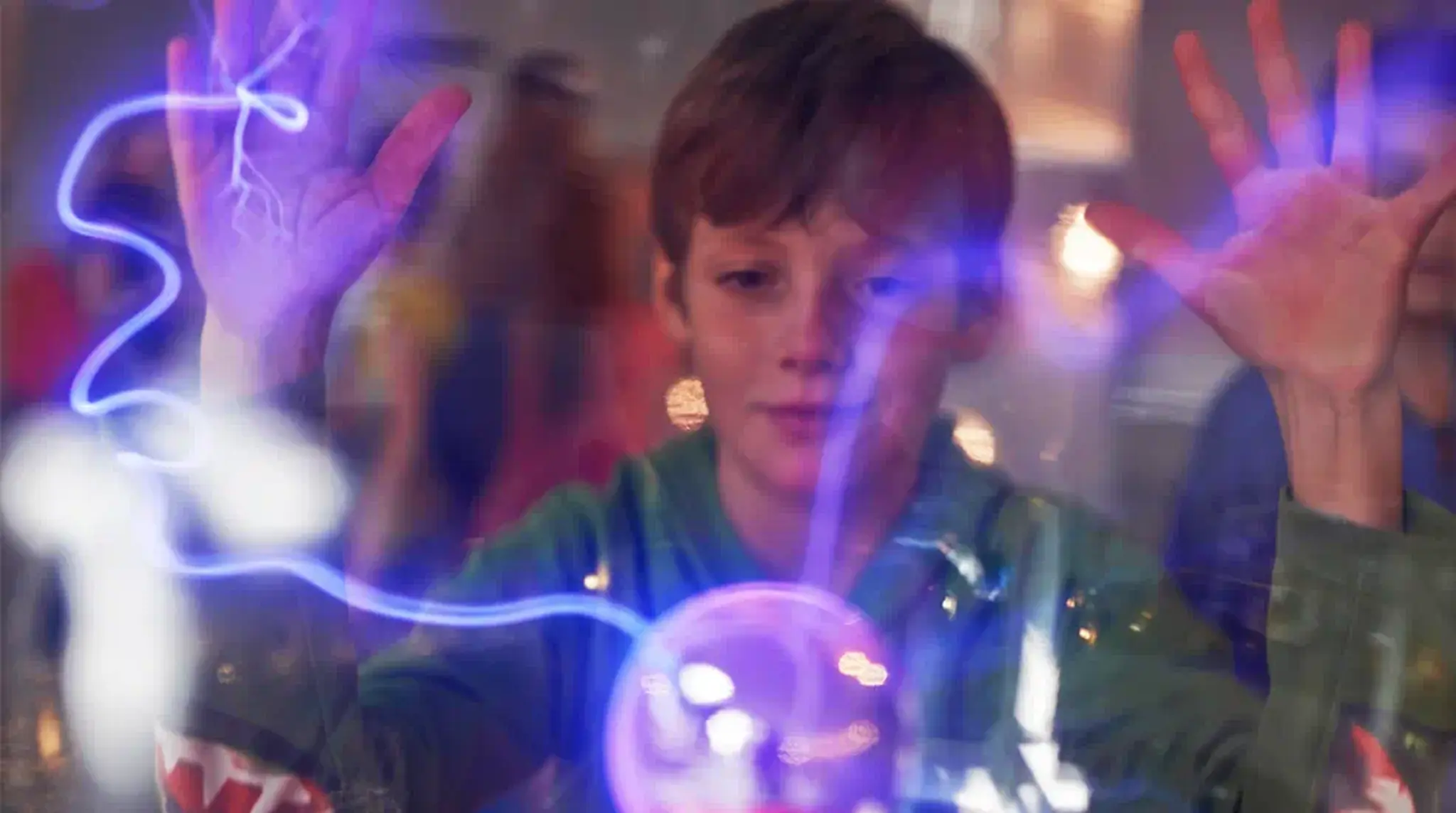 Boy interacts with a plasma ball