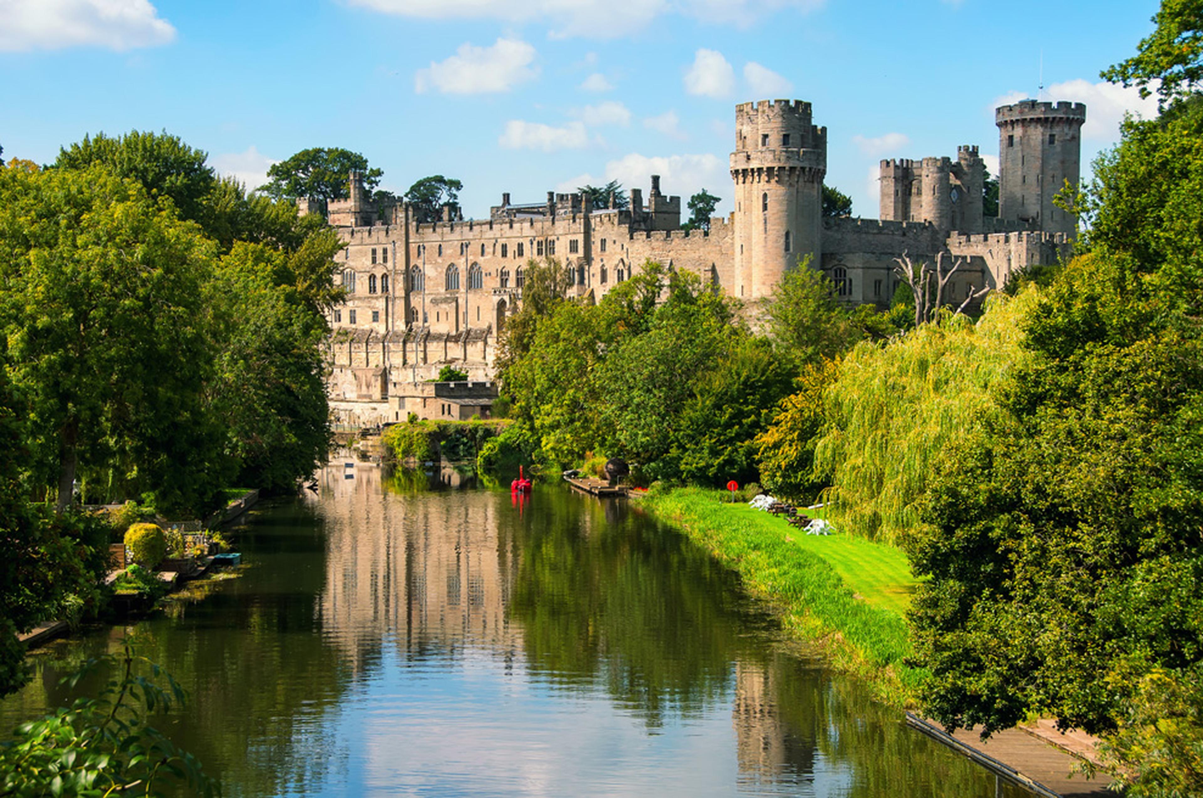 View of Warwick castle by the river.