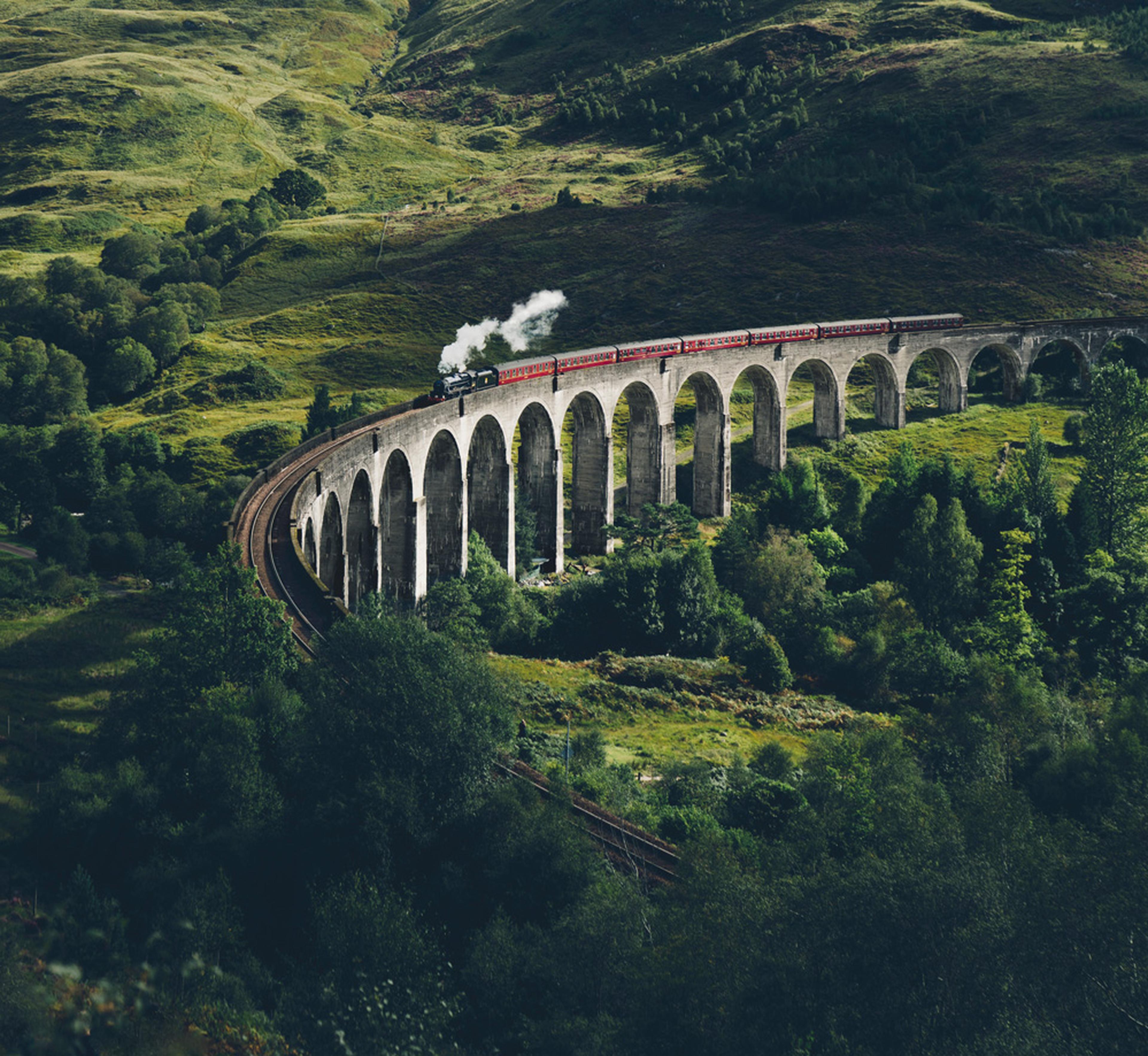 Steam engine crossing and old bridge in Scotland.