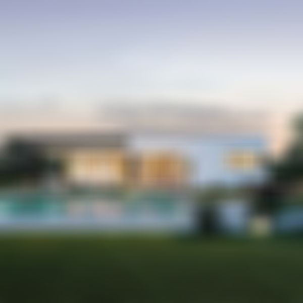 Ein Bungalow mit großen Fenstern, der in der Abenddämmerung beleuchtet ist. Er verfügt über einen Swimmingpool, eine Terrasse und viel Grün in einem großzügigen Garten.