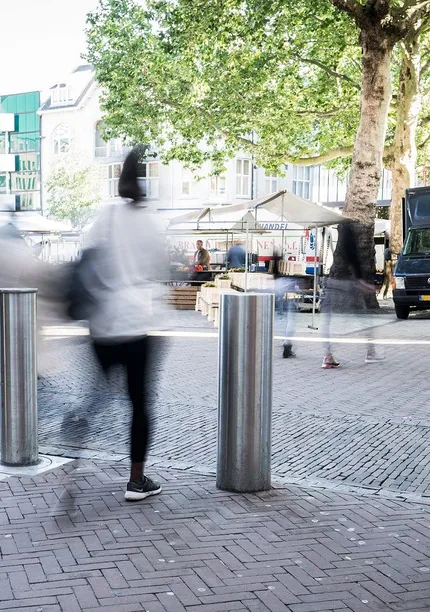 Vrouw loopt door bollards