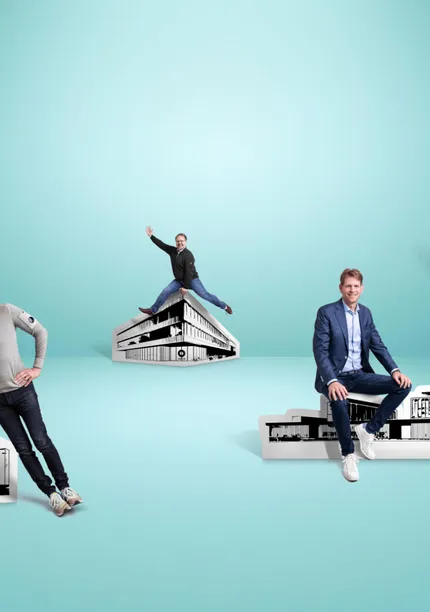 People posing with various black-and-white building cutouts against a blue background. Each individual stands or sits atop a building.