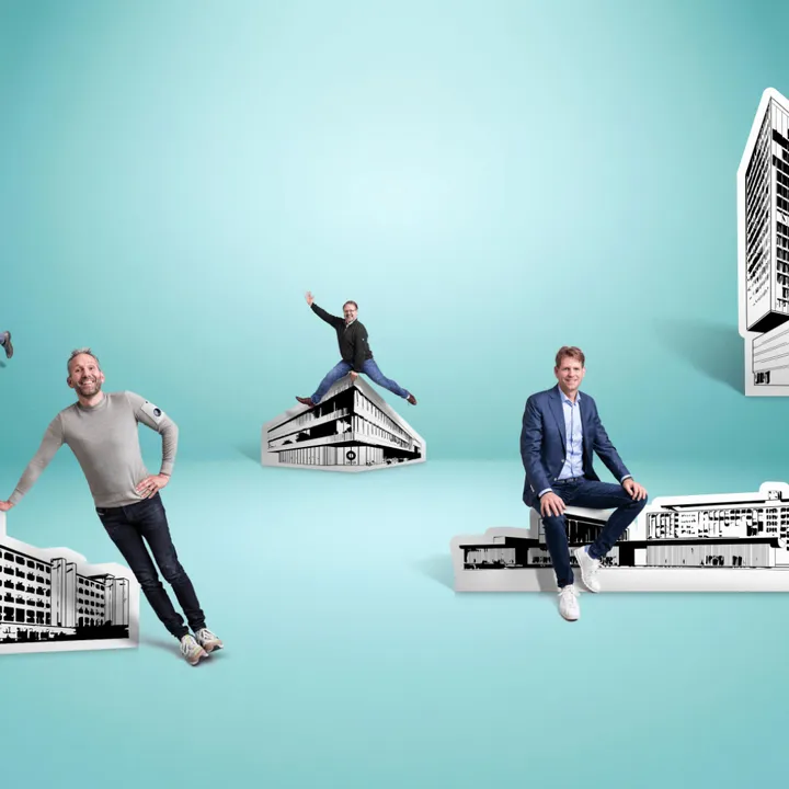 People posing with various black-and-white building cutouts against a blue background. Each individual stands or sits atop a building.