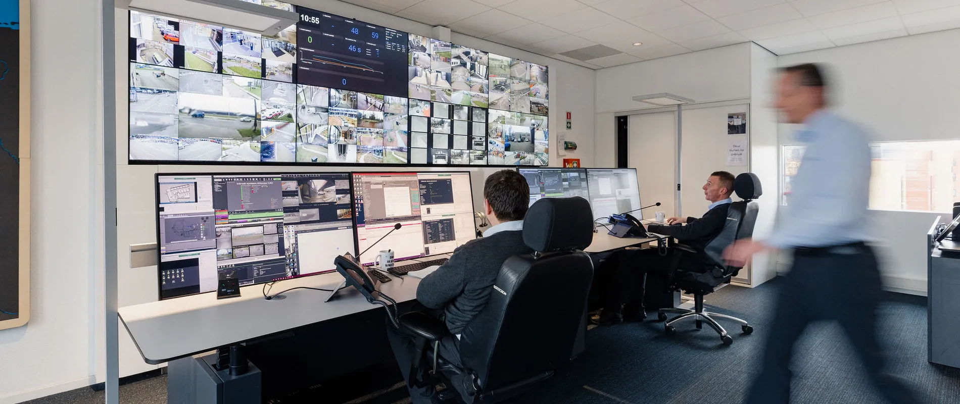 Mannen kijken naar een videowall