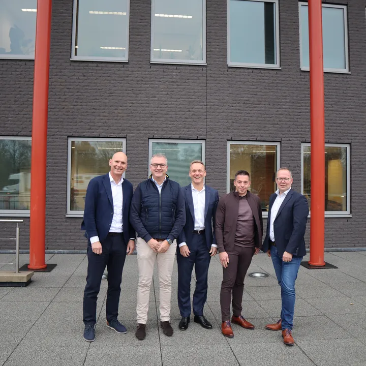 Bestuursleden van Unica en Niemeijer voor het hoofdkantoor van Unica