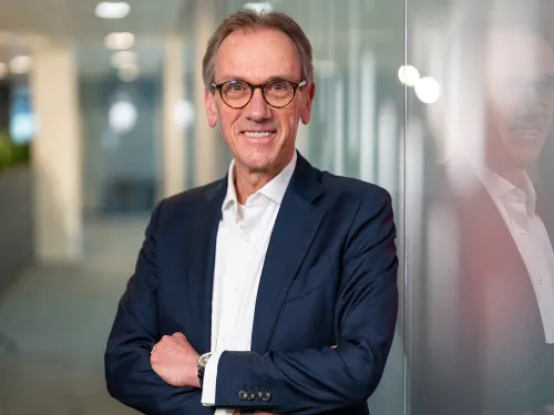Een lachende portretfoto van John Quist, voorheen CEO van Unica