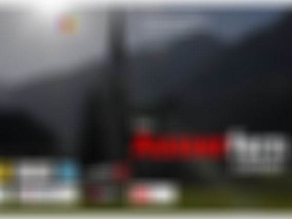 Das Außerfern - Elbigenalp - A church with a tall steeple in a mountainous landscape at sunset, featuring various sponsor logos.