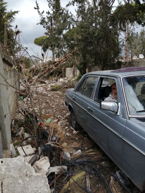 Abu Ali after the ceasefire, driving around a destroyed Kfar Kfila. 