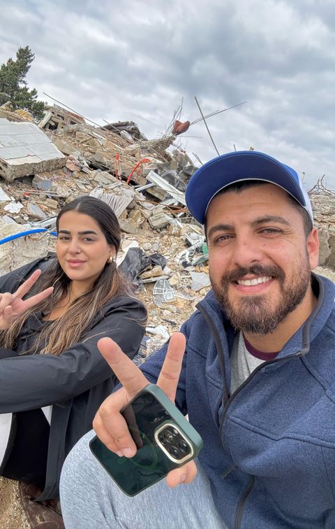 Nour and her husband and the wreckage of their home.