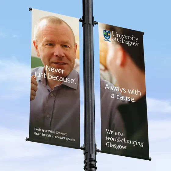 Two banners on a pole display University of Glasgow