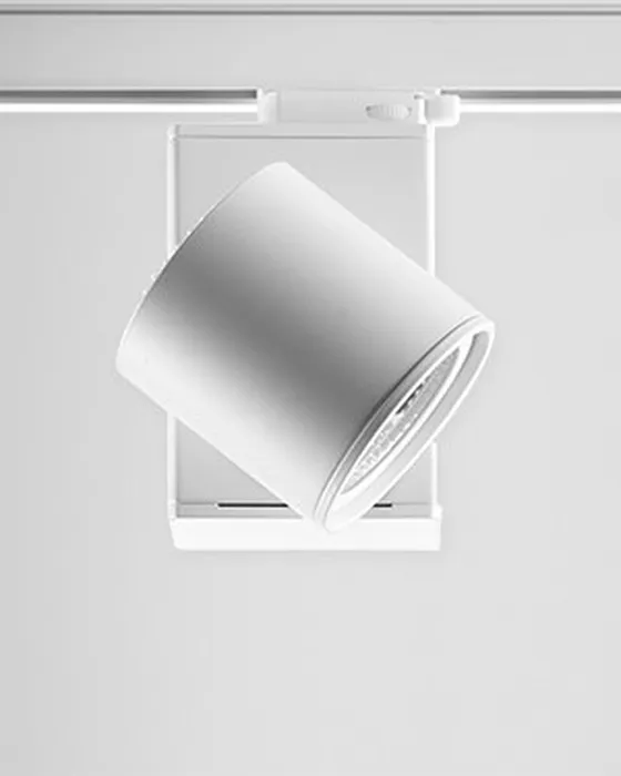 Cylindrical white Simon 640 spotlight on track showing the invisible joint that enables orientation