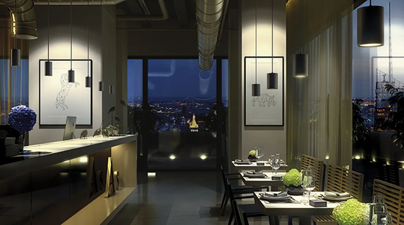 Nighttime restaurant with panoramic views lit by suspended black Simon 640 spotlights