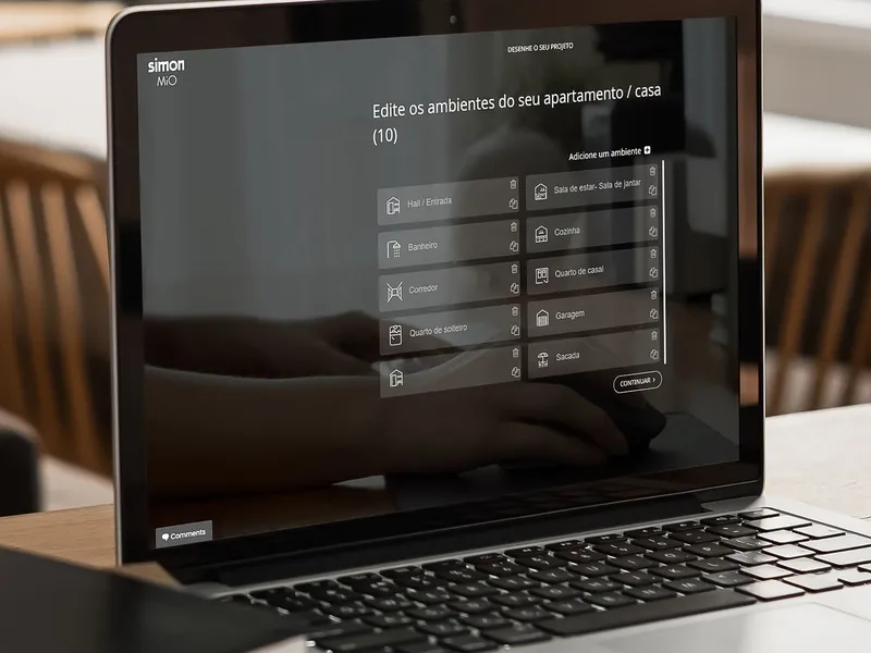 Hand holding a smartphone with the Simon iO interface to control Simon 810 linear lighting