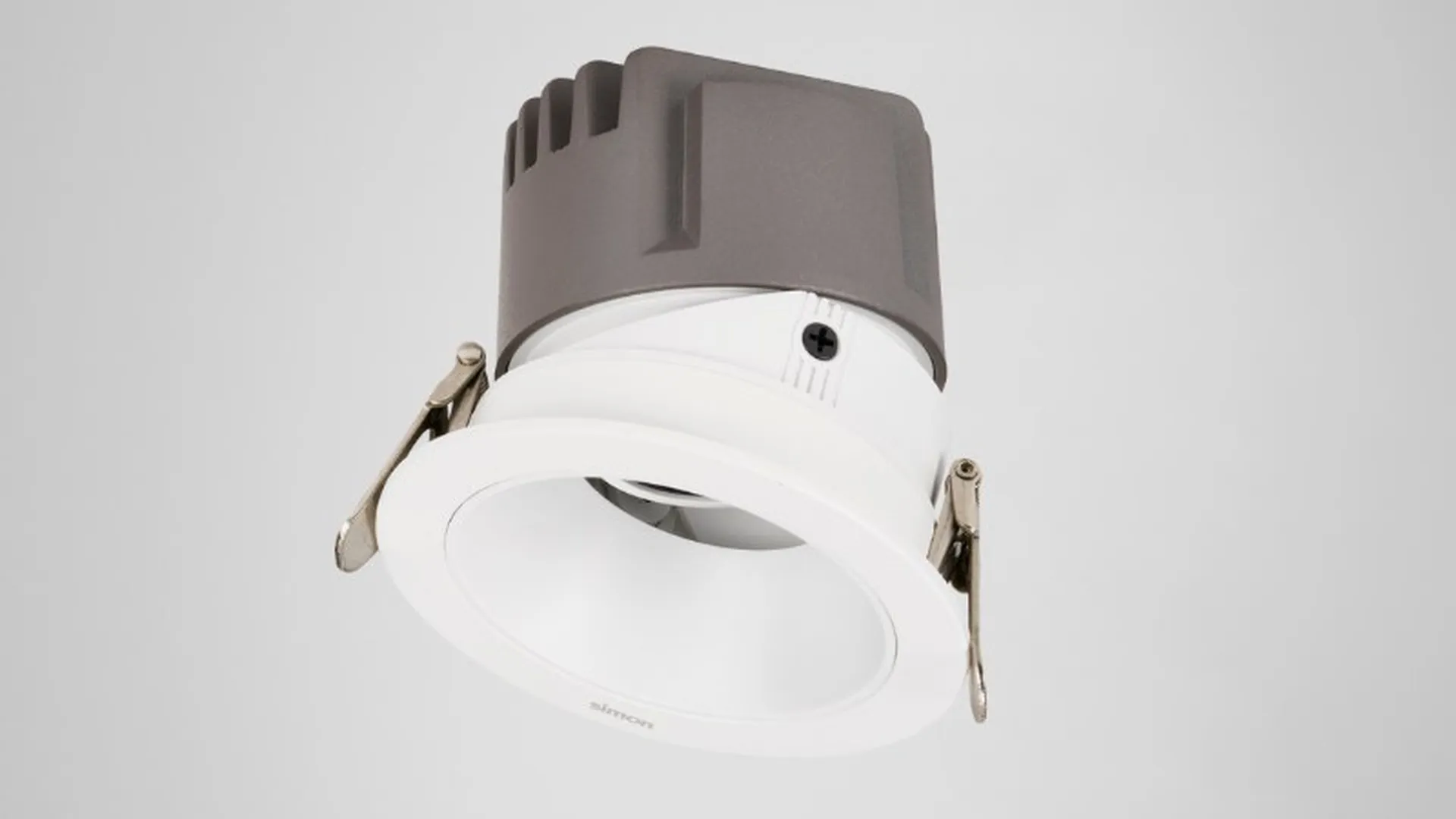 Round white tiltable Simon 709 downlight, 3/4 view on light background