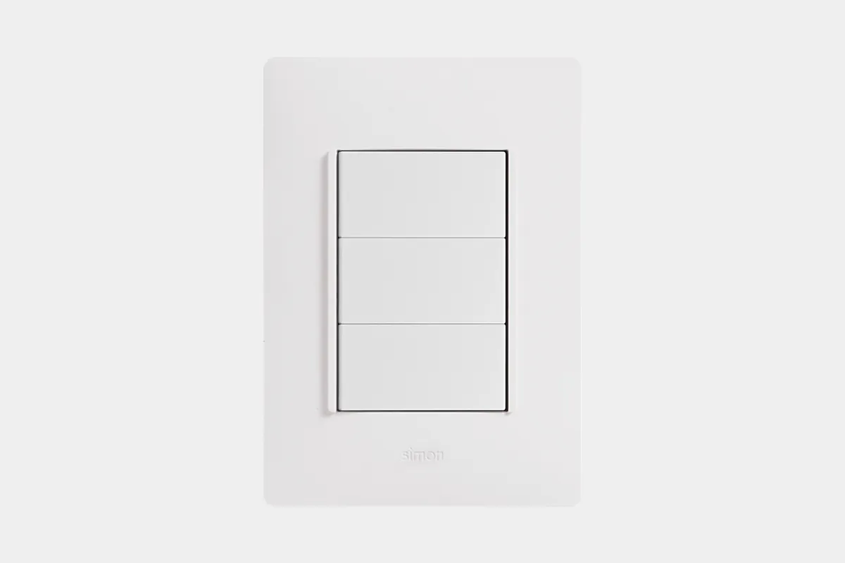 Simon 26 ORIGEN range — white-finish plate with two graphite keys on a neutral background.