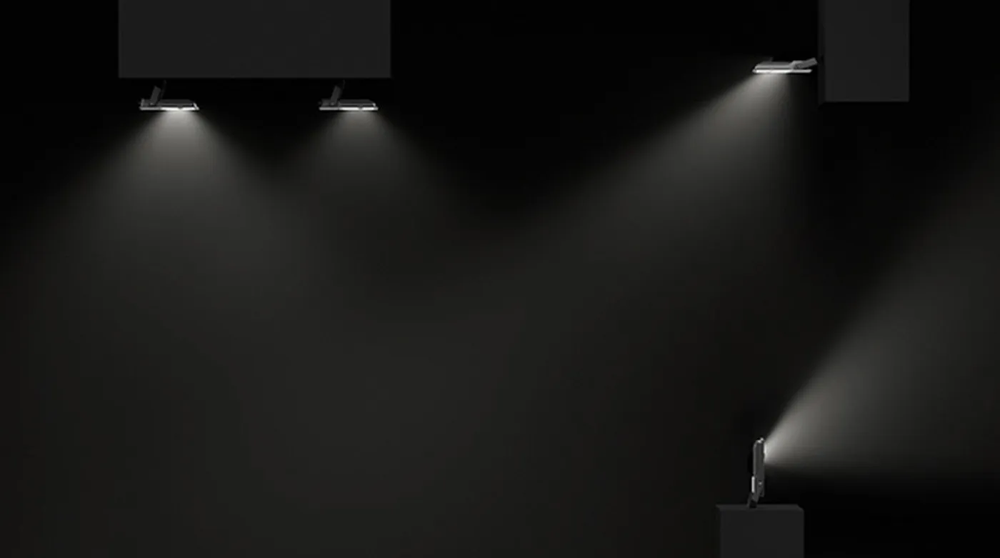Simon 880 watertight industrial spotlights in operation projecting light onto surfaces in an industrial environment
