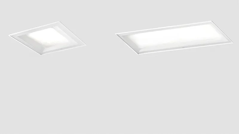 Dos luminarias modulares Simon 720 base en formatos cuadrado y rectangular sobre techo gris