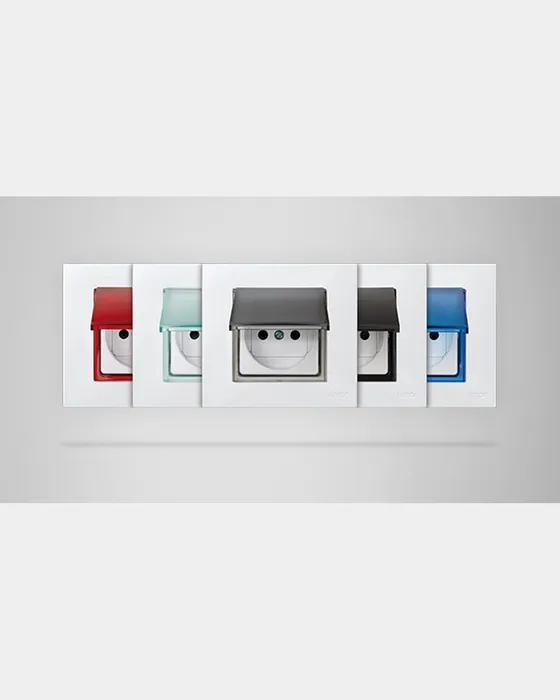 Simon 27 Play hinged caps in five finishes (red, green, smoke, graphite, blue) on grey background