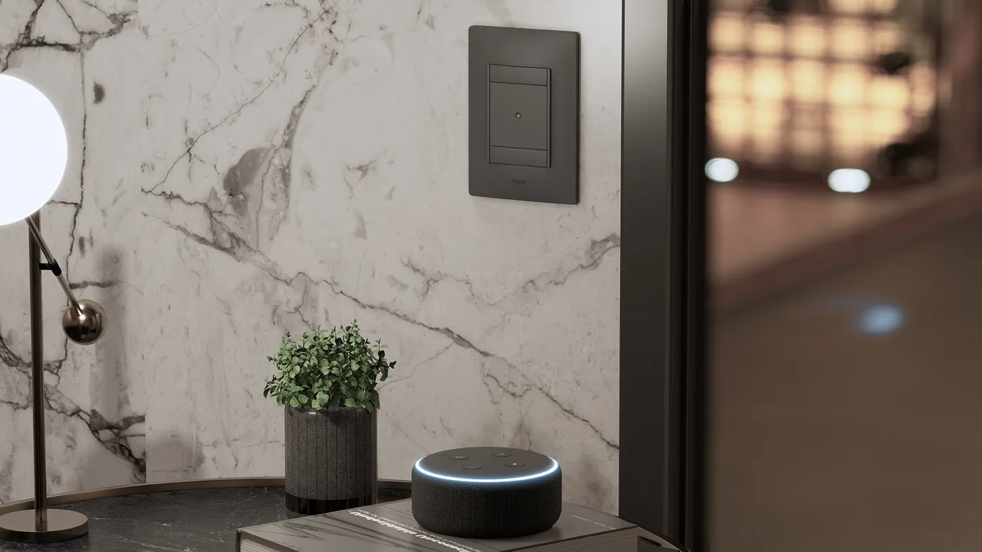 Living room setting with a black Simon 26 iO switch on a white marble wall, an Amazon Echo speaker on the coffee table and a spherical lamp.
