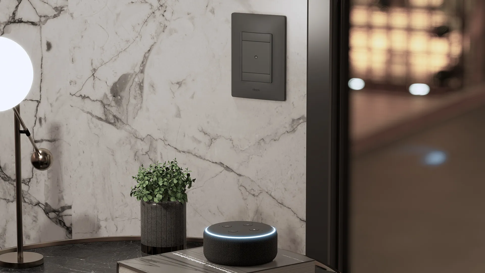 Living room setting with a black Simon 26 iO switch on a white marble wall, an Amazon Echo speaker on the coffee table and a spherical lamp.