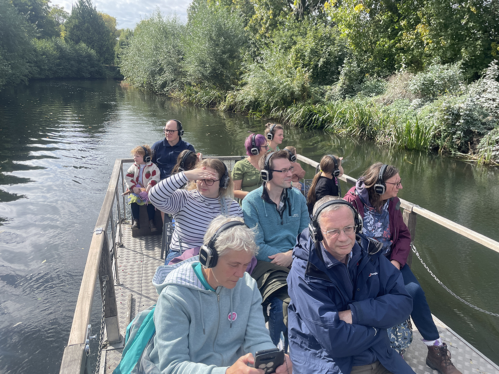 The audience are looking out at the scenery while listening to the audio work