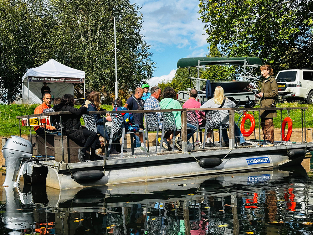 Feral Practice introducing the soundwork to the audience on the raft