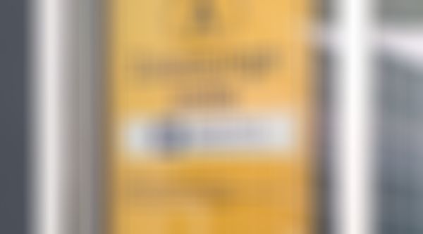 Gelbes Schild einer österreichischen Zulassungsstelle der GARANTA Versicherungs-AG