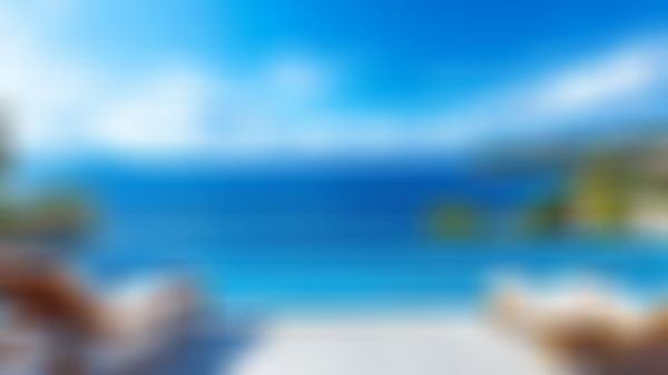 Blick von Hotelterrasse aufs offene Meer mit blauem Himmel