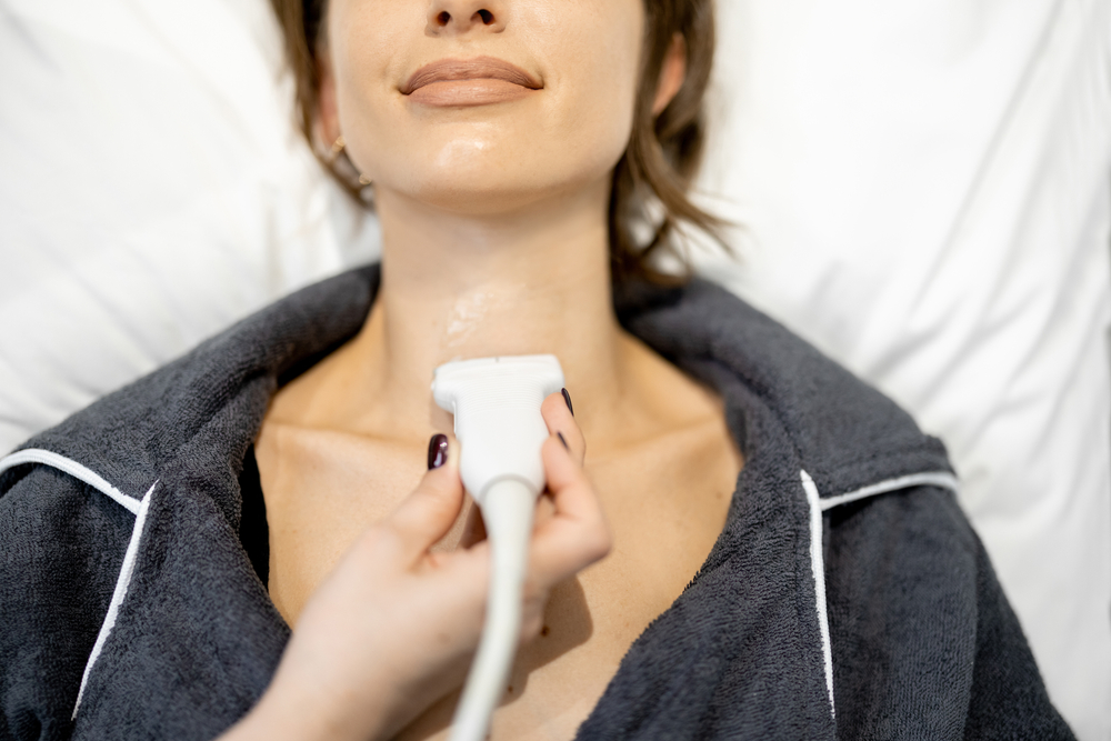 Doctor examining thyroid of female