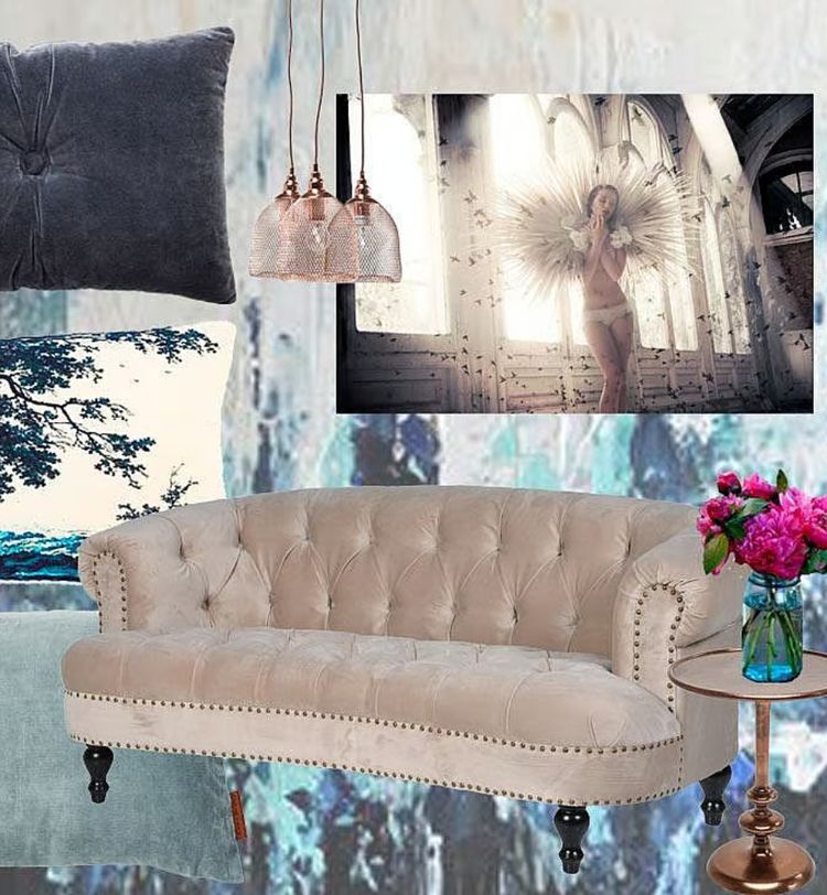Elegant living room with a beige tufted sofa, floral cushion, pink flowers on a round table, and a framed angelic artwork on the wall.