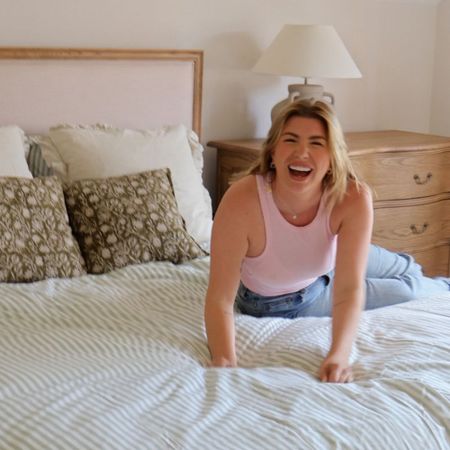 Olivia Bowen sitting on our Love Story Naturelle Bed, with various French Bedroom accessories