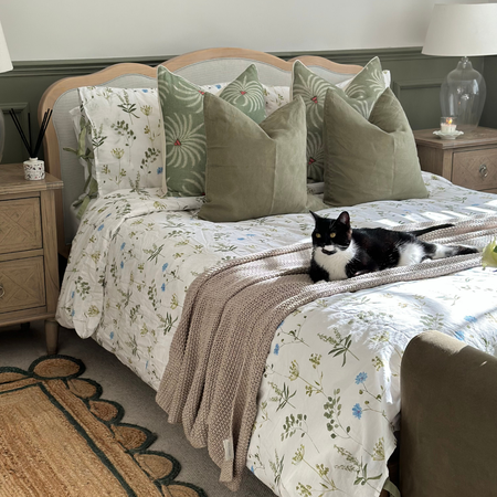 melange cushion in olive styled with meadow botanical bedding