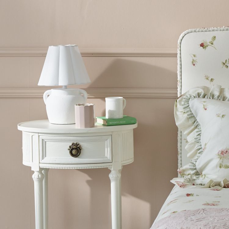 White Table lamp on bedside with small handles and scalloped shade