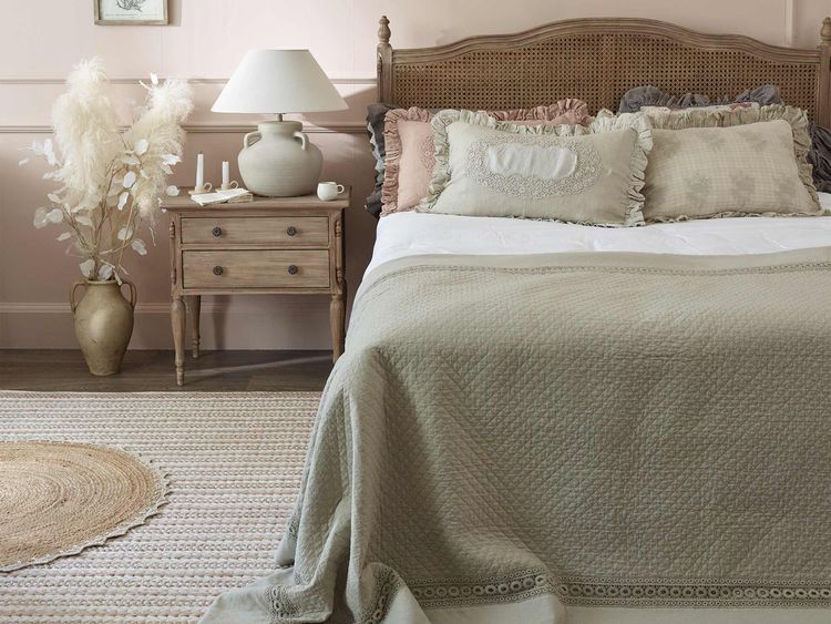 Clair de Lune Rattan bed styled with Jute rugs and ruffle cushions