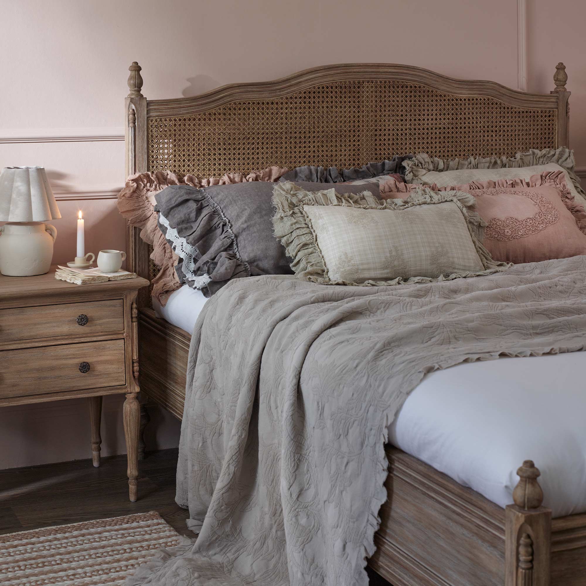 double layered rattan bed frame styled with ruffle lace cushions