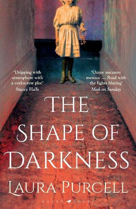 Cover of "The Shape of Darkness" by Laura Purcell, featuring a girl in vintage clothing standing in a dimly lit, eerie hallway.