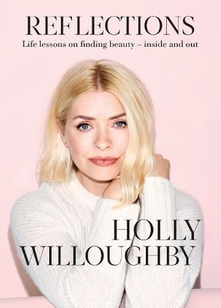 A woman with blonde hair in a white sweater poses against a pink background. The text reads "Reflections" and "Holly Willoughby."
