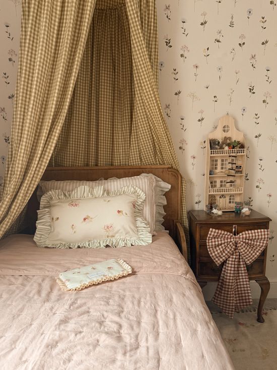 Children's bedroom with pink blanket and floral ruffle cushion