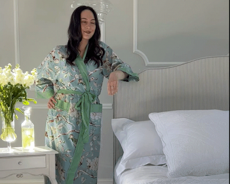 Happy woman in a nightdress animated to show sparkles as she clicks her finger