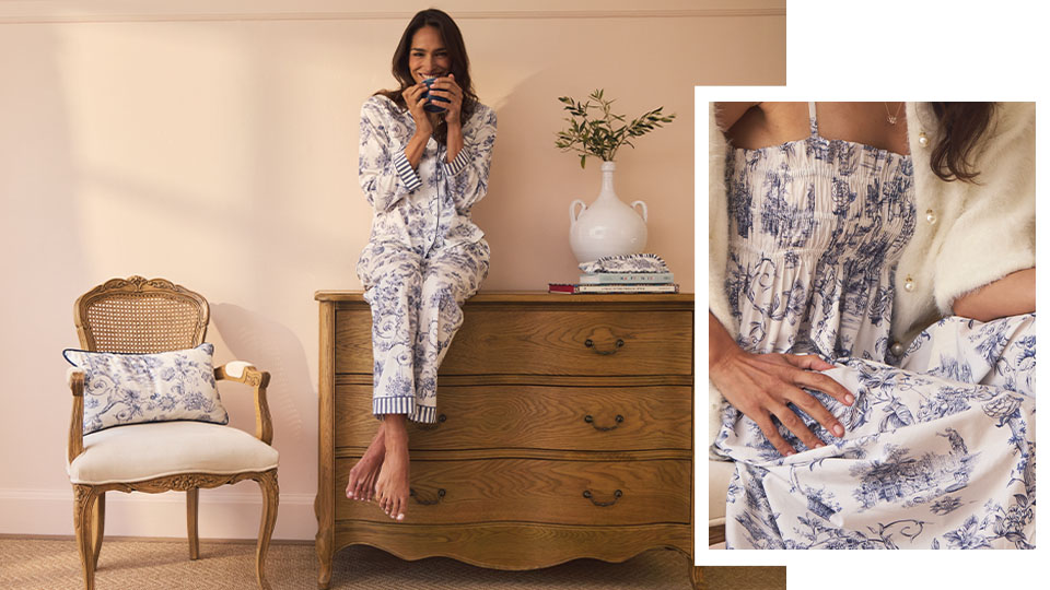 Woman in toile print pyjamas sits on a dresser, holding a mug. Background shows a chair with a matching French toile cushion and  an overlayed image shows a close-up of matching Toile nightdress.