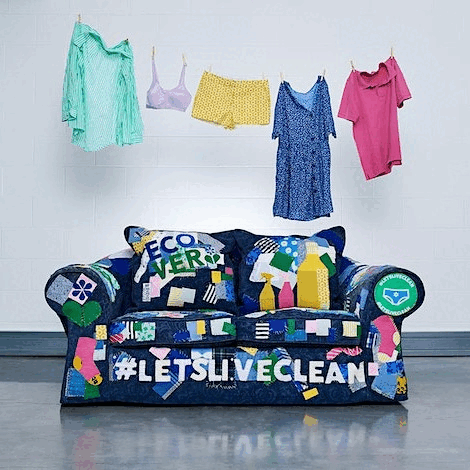 Colorful clothes hanging above a vibrant patchwork sofa