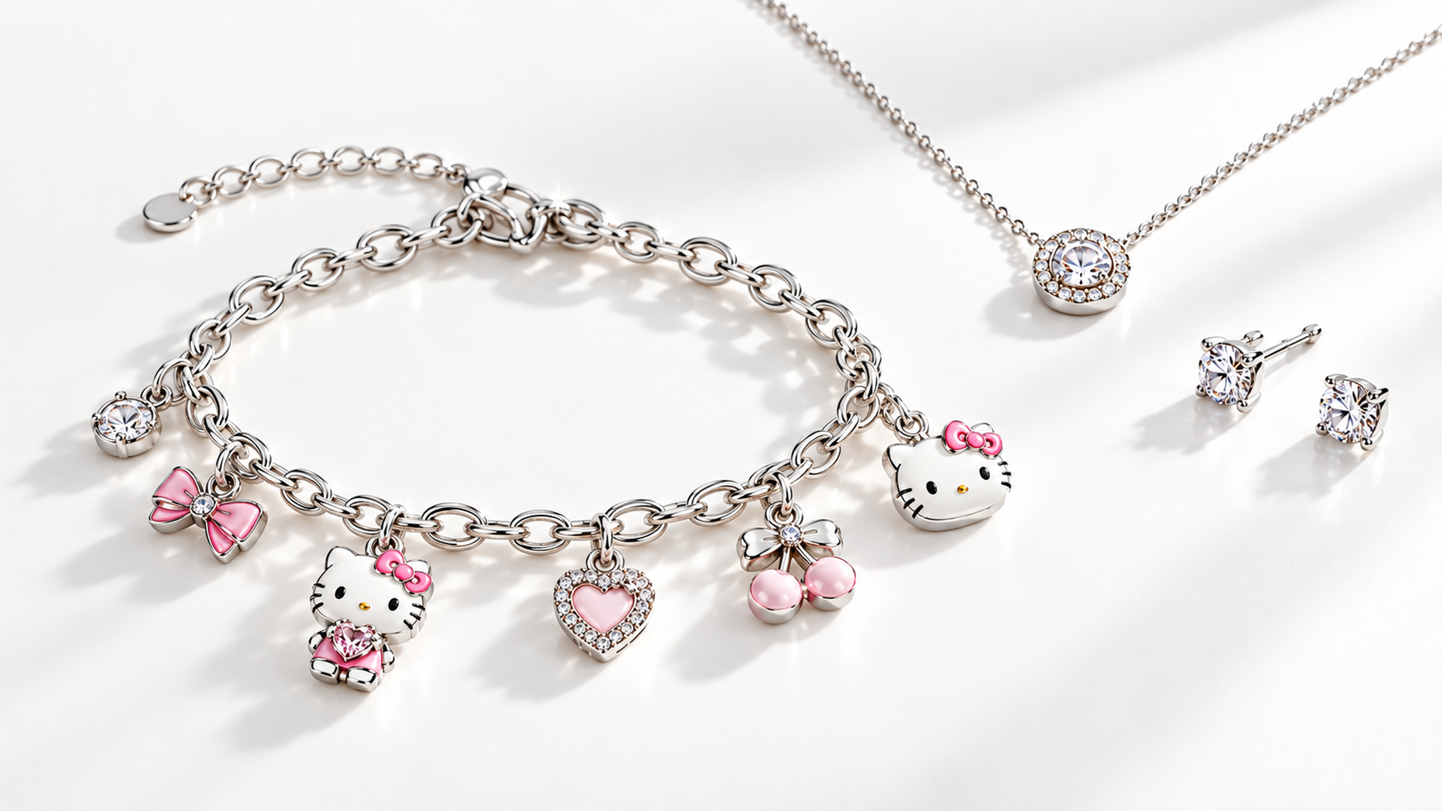 Silver jewelry set with cute character charms, including a bracelet, necklace, and earrings adorned with pink accents and crystals.