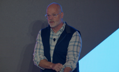 Presenter Deane Barker from Staffbase presenting Narrative Content: Storytelling Over Time session to attendees on the main keynote stage at JoyConf New York NY.