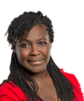 Woman with braided hair wearing a red top, smiling softly against a white background.