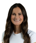 Smiling woman with long brown hair wearing a white shirt, facing forward against a plain white background.
